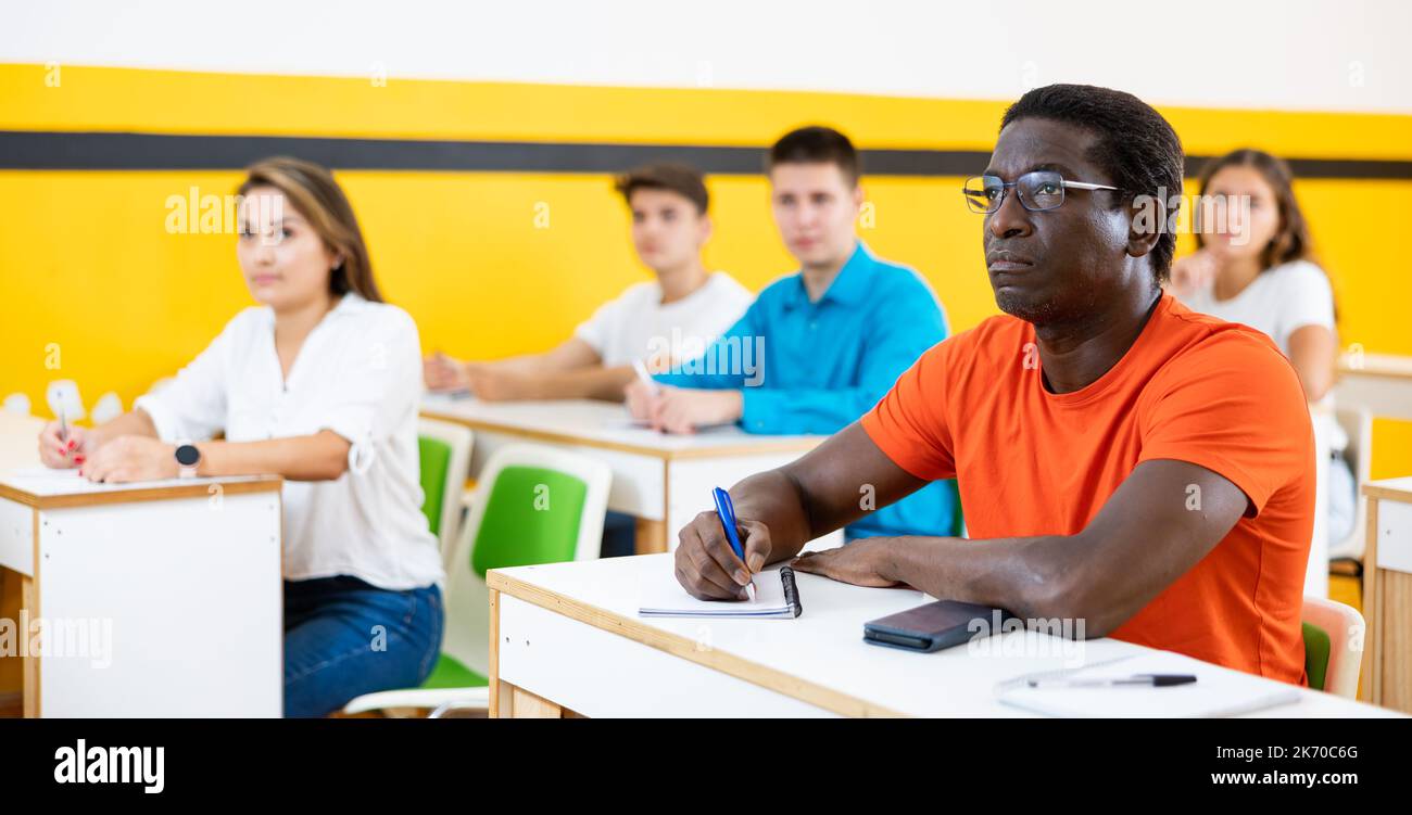Man attending lecture in taxi training school Stock Photo