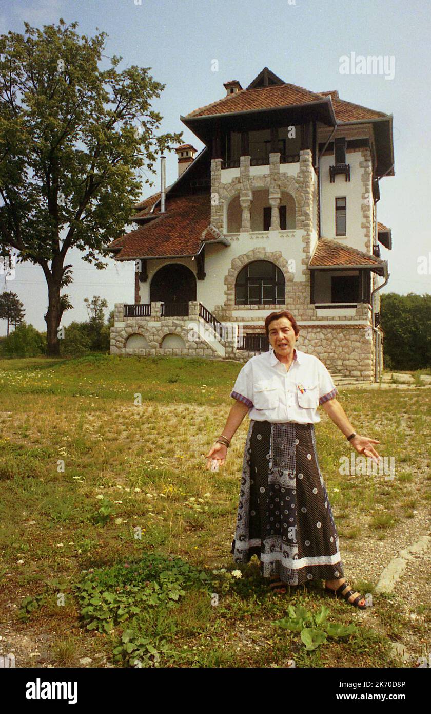 Bran, Brasov County, Romania, 2000. Owner of an exquisite house standing in her front yard. Stock Photo