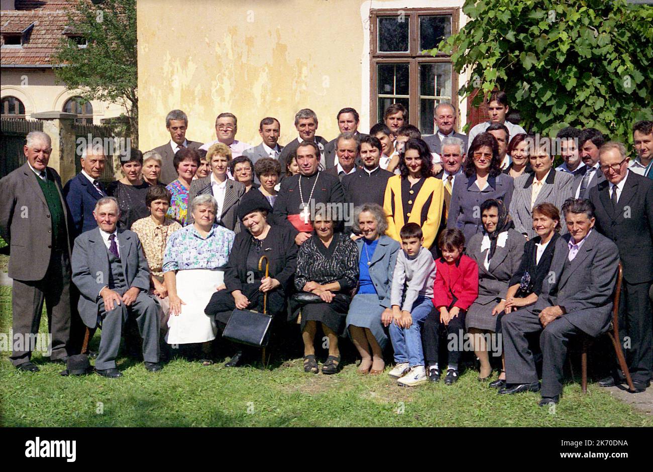 Cața, Brasov County, Romania, approx. 2000. Group of parishioners with priest Sebastian Pedestru outside the local Christian Orthodox church. Stock Photo