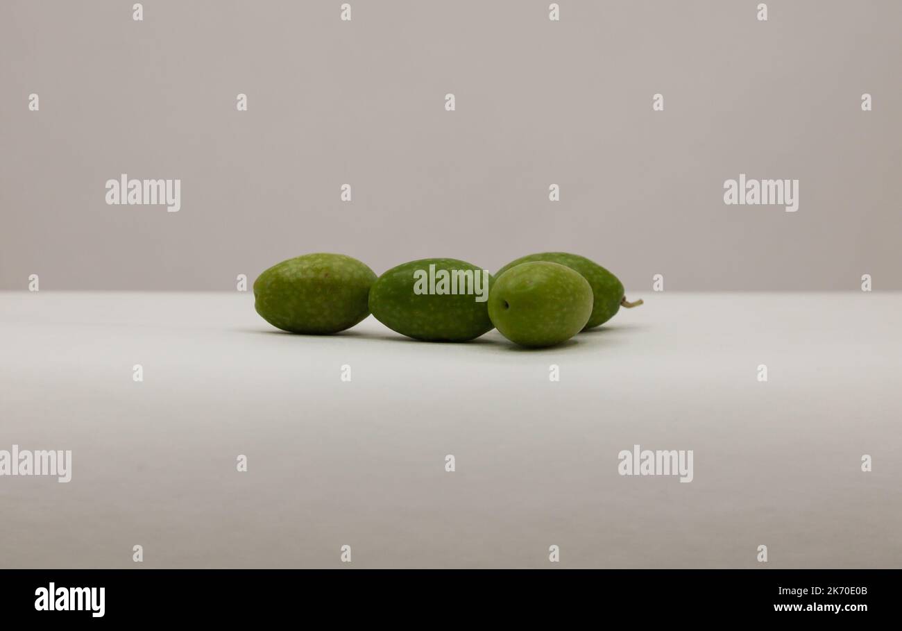 Large green olives are isolated background. Olives freshly picked. Stock Photo