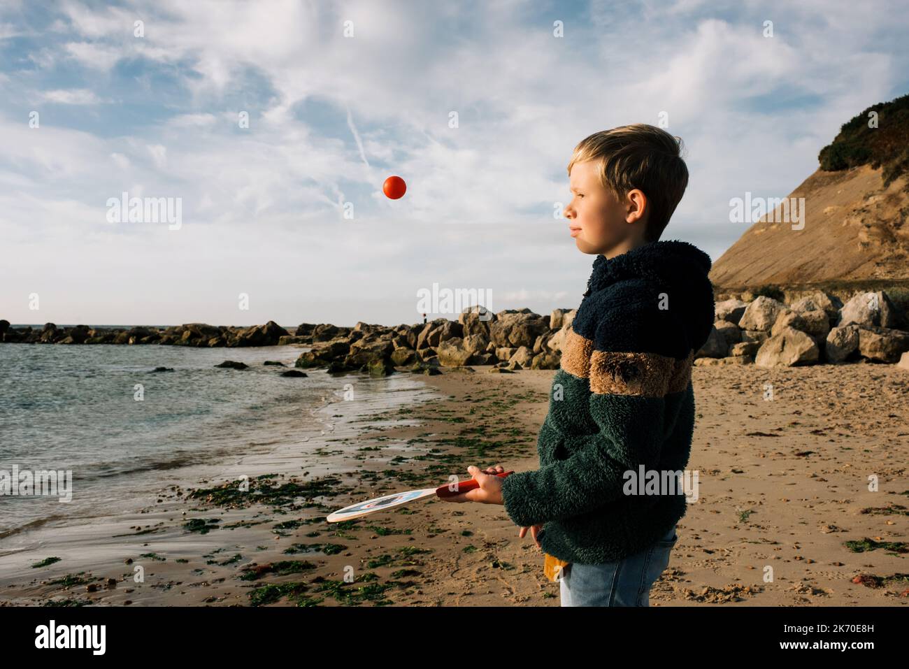 boy playing bat and ball happily at the beach Stock Photo Alamy
