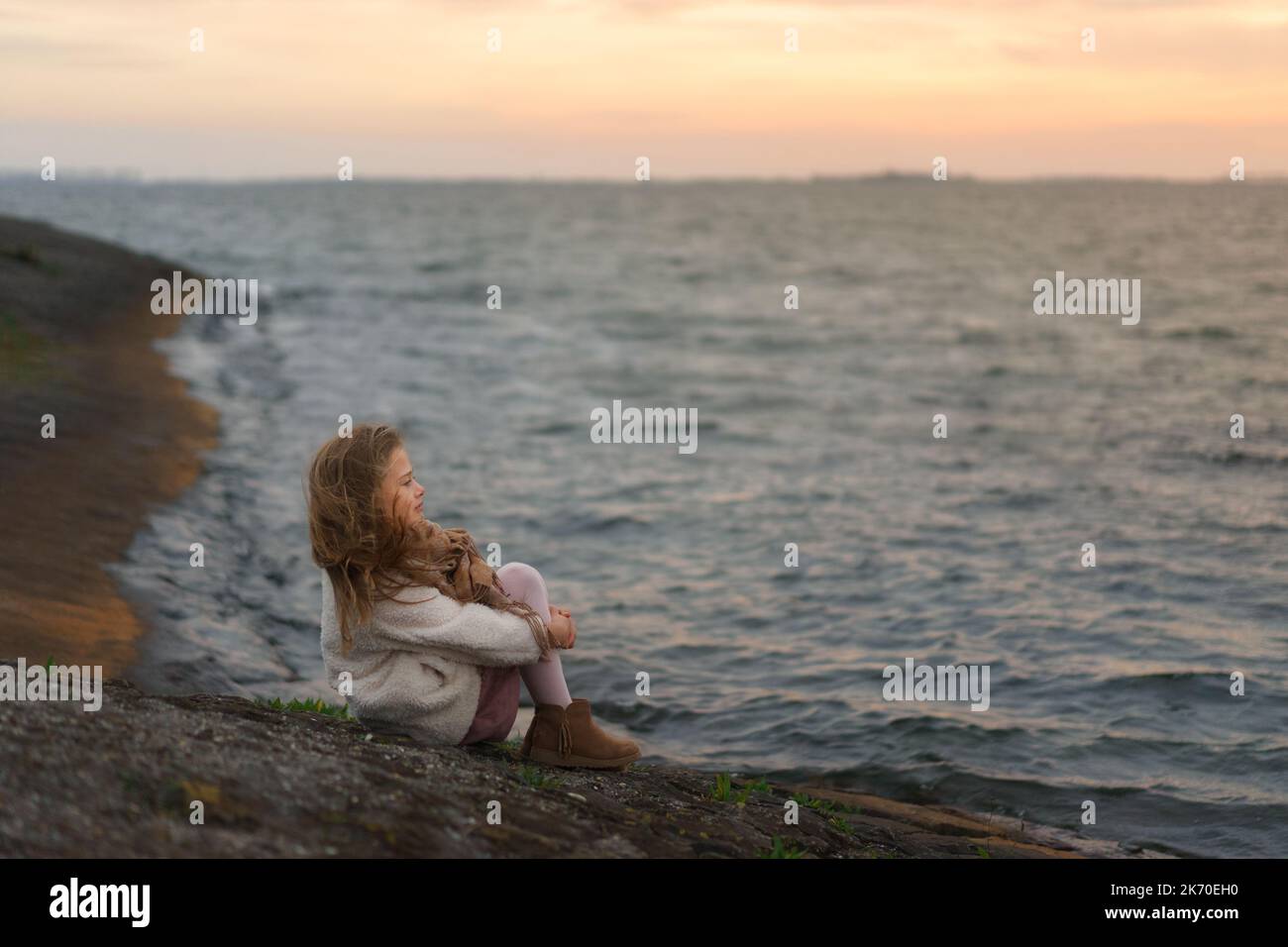 Young girl watching the see. Stock Photo