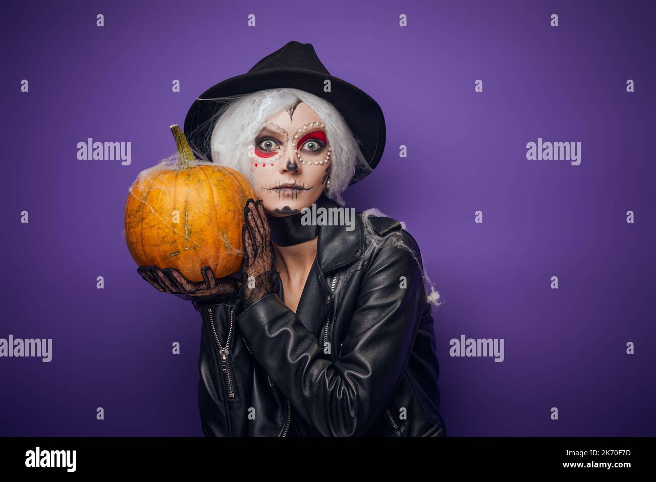 Scared surprised witch with grey hair on Halloween Stock Photo