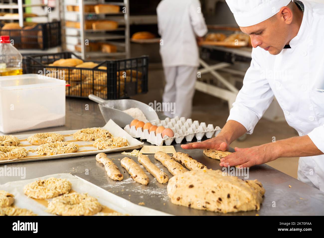 Baker preparing sweet buns hi-res stock photography and images - Alamy
