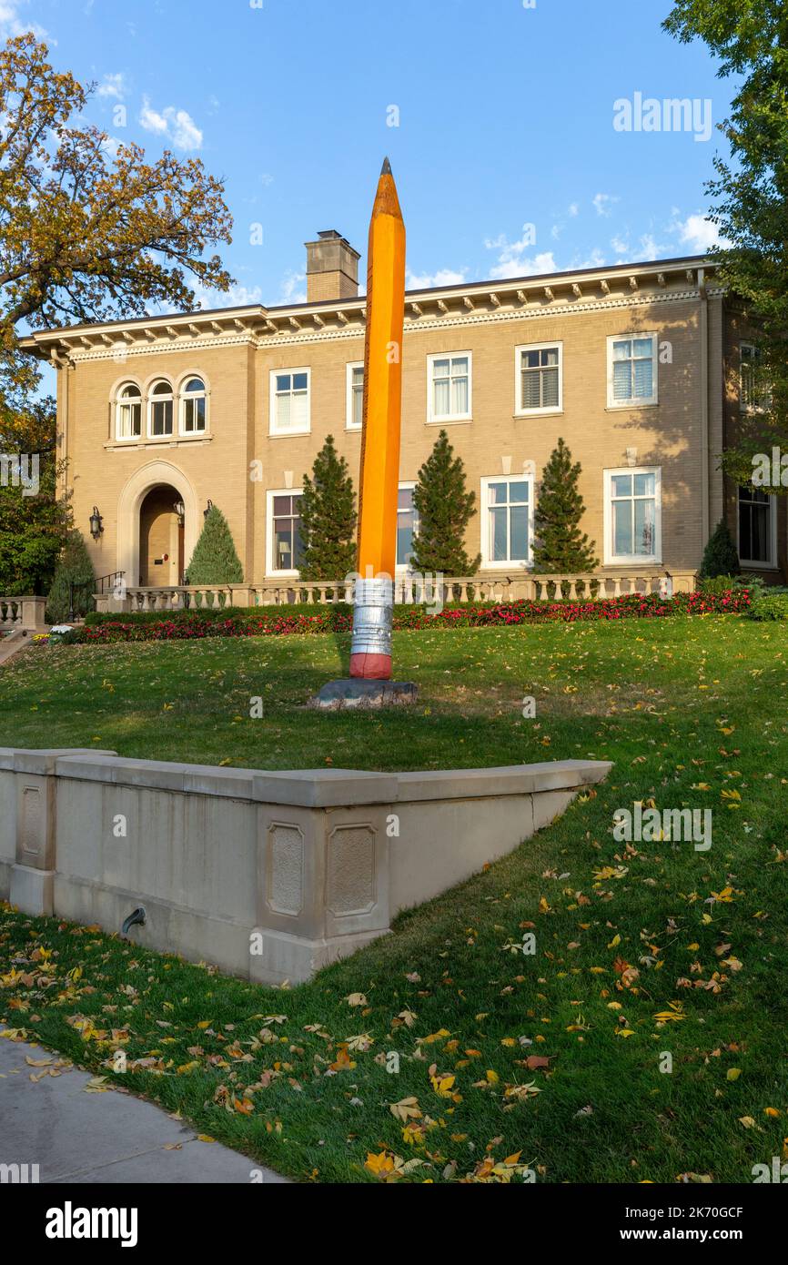A 16 foot high #2 pencil sculpture was carved from a storm damaged bur oak tree in 2022.  The sculpture is located along Lake of the Isles in Minneapo Stock Photo