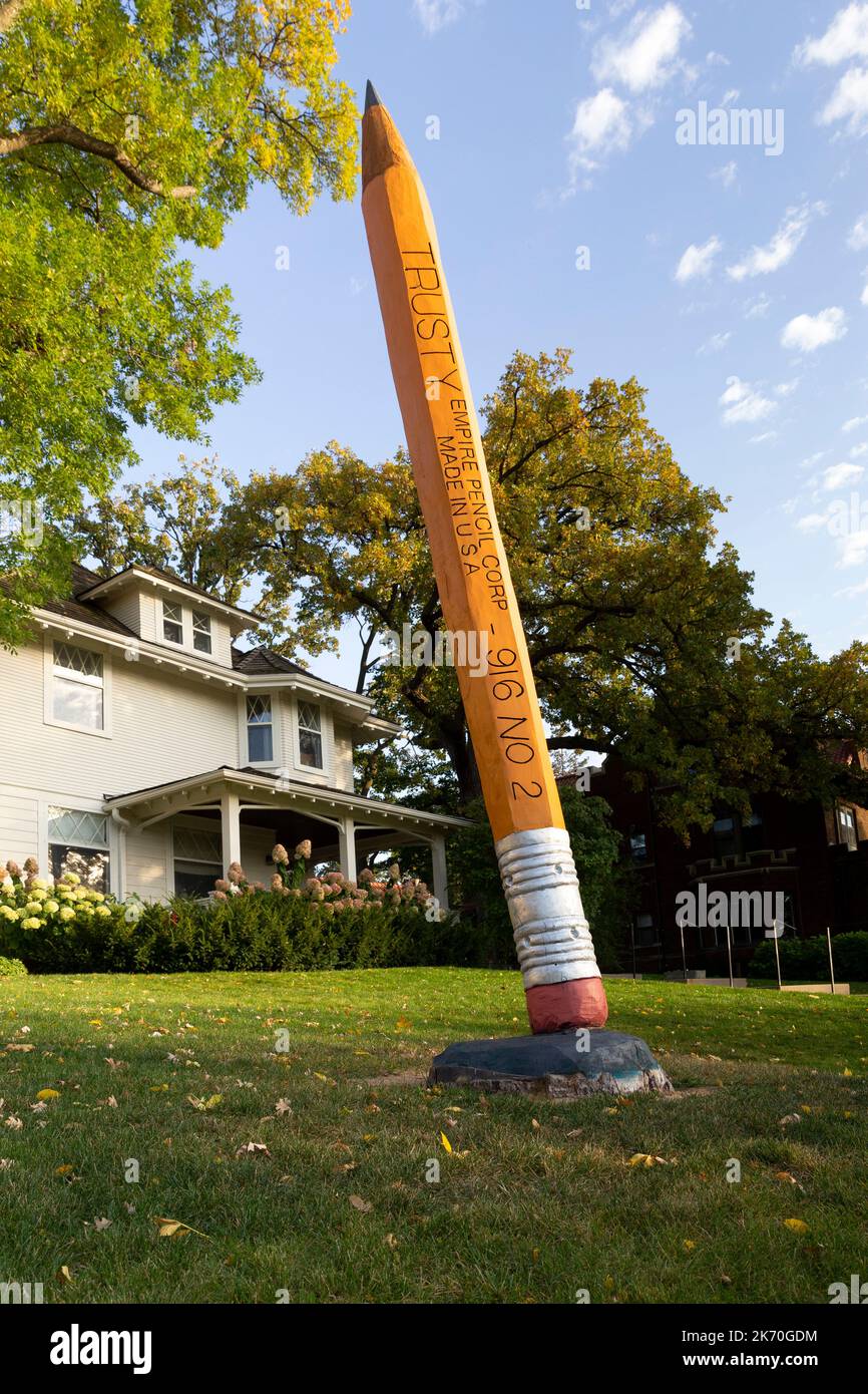 A 16 foot high #2 pencil sculpture was carved from a storm damaged bur oak tree in 2022.  The sculpture is located along Lake of the Isles in Minneapo Stock Photo