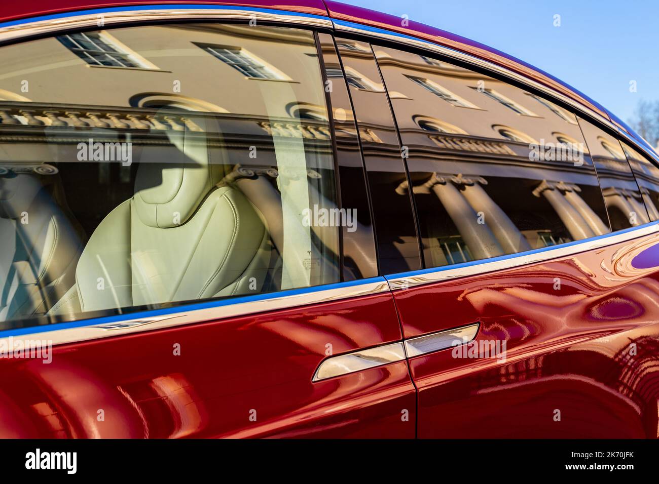 A beautiful Tesla  vehicle is parked outside  part of the famous Nash Terraces in central london.The image shows  Nash buildings reflected in the car Stock Photo
