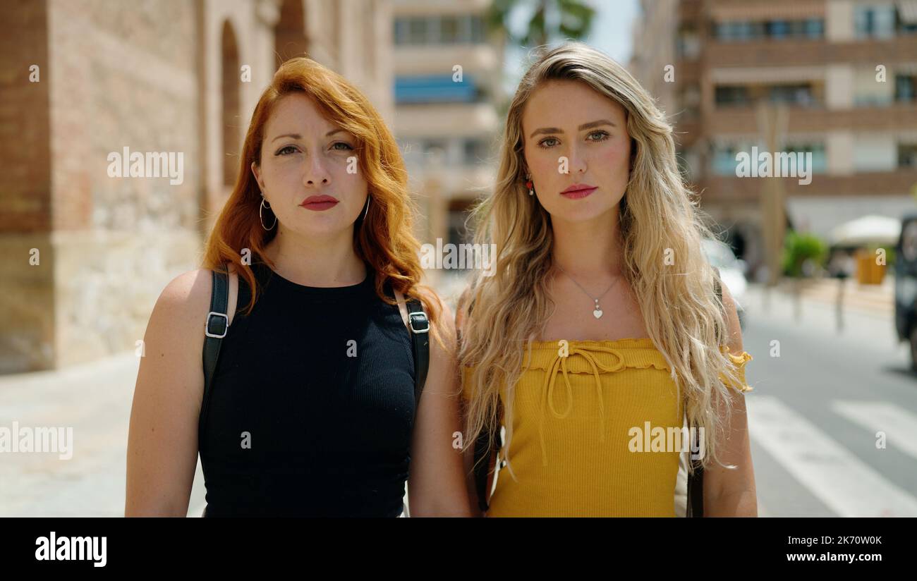Two women standing together with relaxed expression at street Stock ...