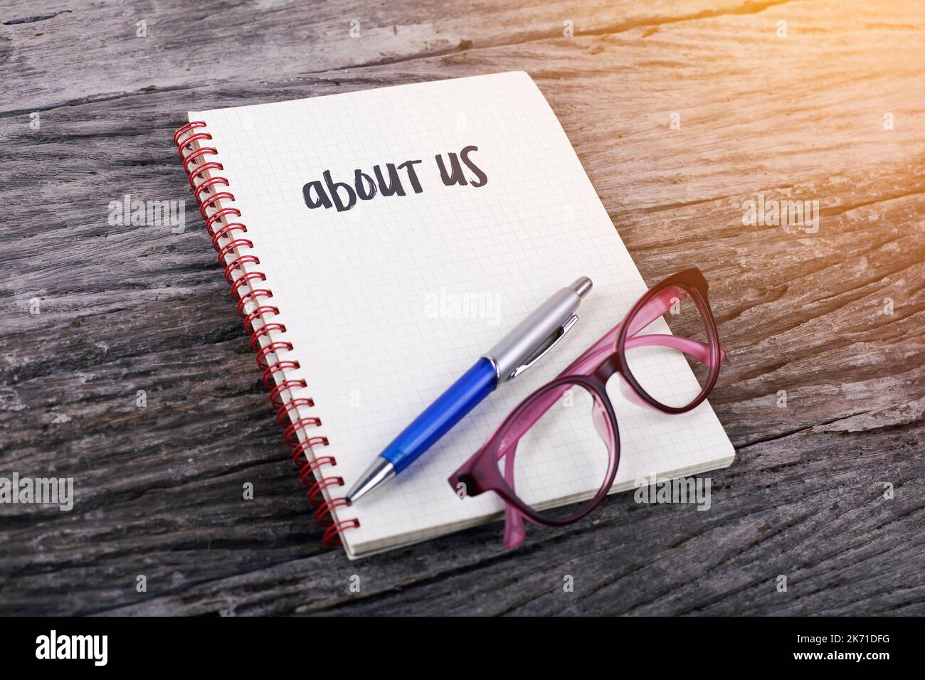 Note with about us on the wooden background Stock Photo