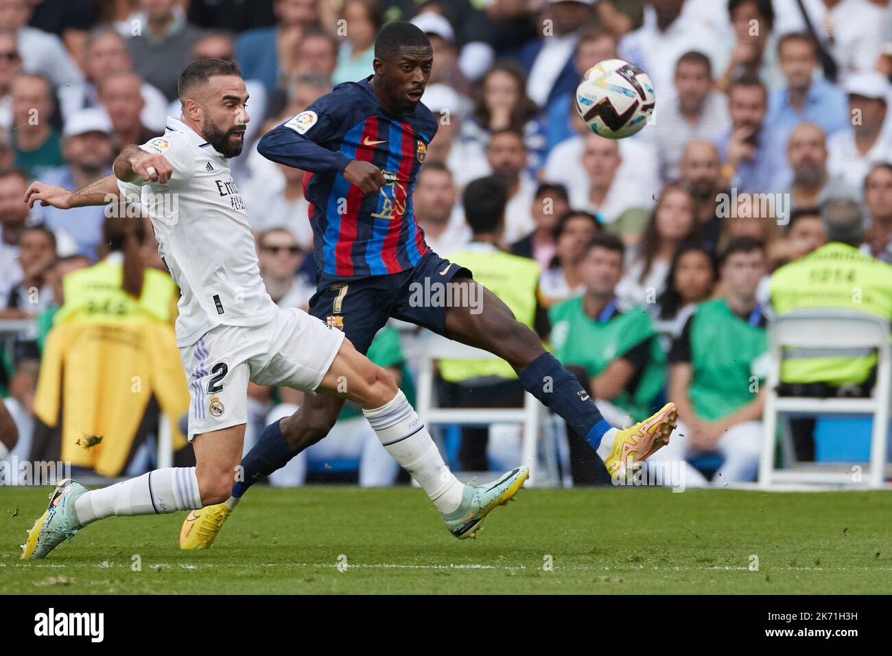 Madrid, Spain. 16th Oct, 2022. Daniel Carvajal (L) of Real Madrid vies with Ousmane Dembele of Barcelona during a La Liga football match between Real Madrid and FC Barcelona in Santiago Bernabeu Stadium, Madrid, Spain, Oct. 16, 2022. Credit: Meng Dingbo/Xinhua/Alamy Live News Stock Photo