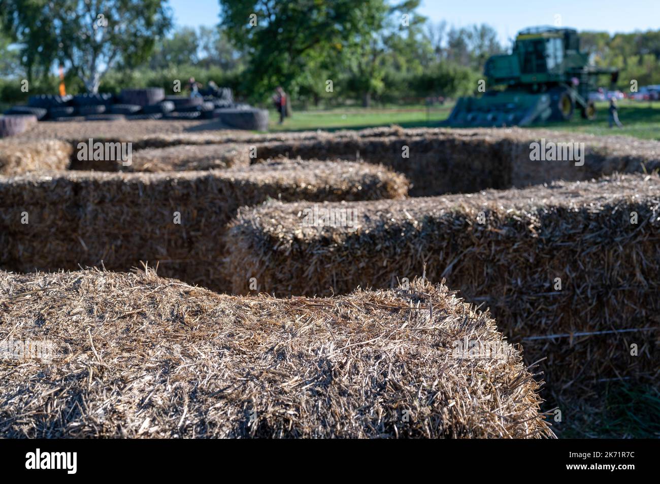 Straw bale maze with child going along a path towards the center.  Stock Photo