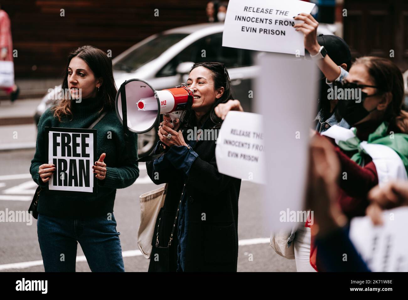 A protester speaks through a megaphone during an emergency rally in