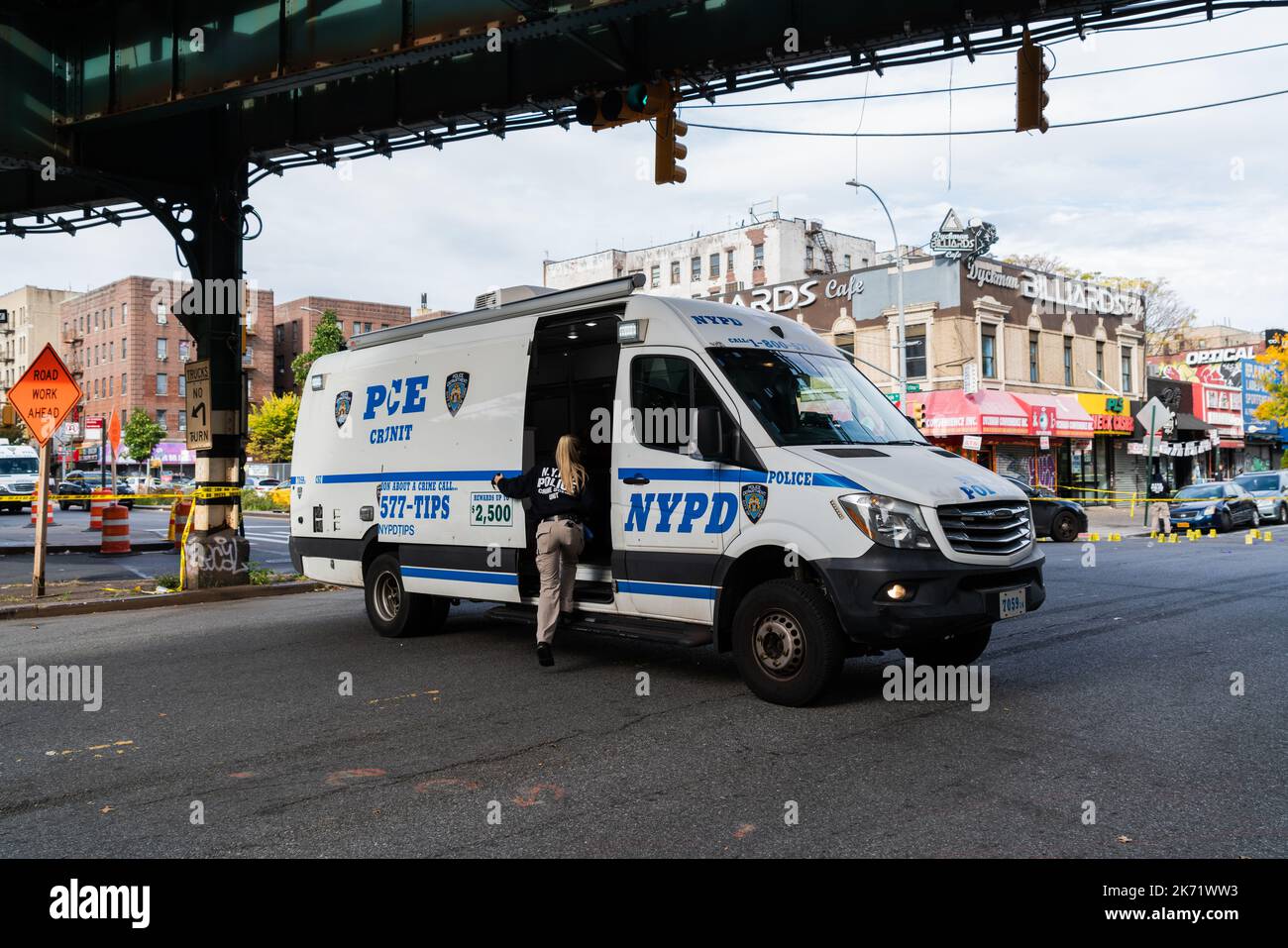 Members of the Crime Scene Unit investigate a police shooting with ...