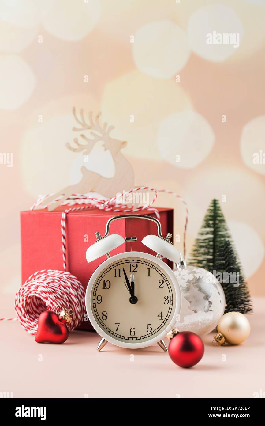 Christmas composition with holiday decorations, alarm clock and gift box.  Stock Photo