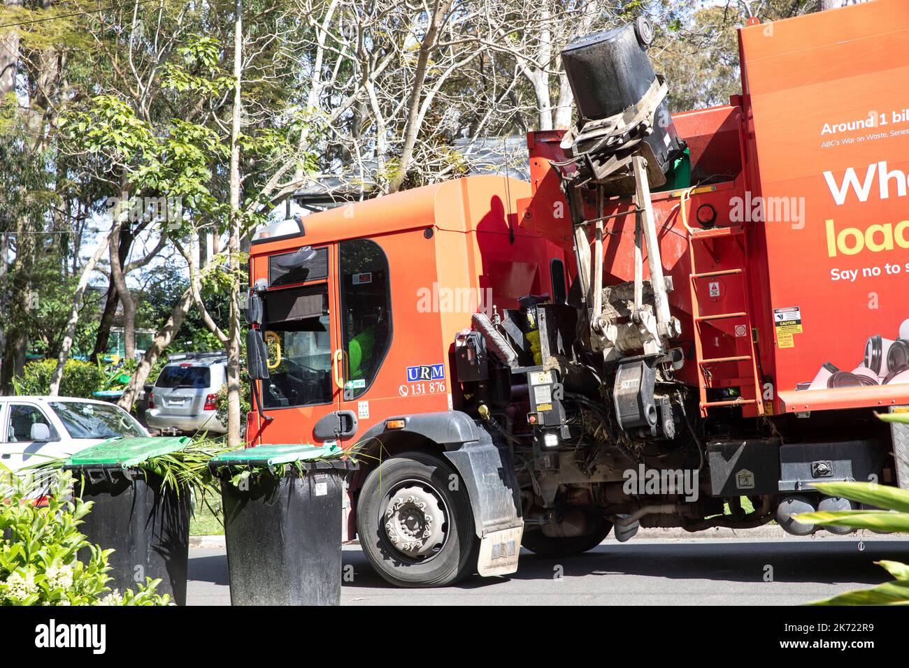 Australia, council vehicle picks up and empties green waste vegetation