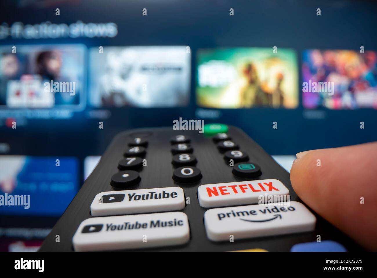 Melbourne, Australia - Oct 13, 2022: Wide angle macro shot of browsing content on streaming services in smart TV using remote control, shot with macro Stock Photo