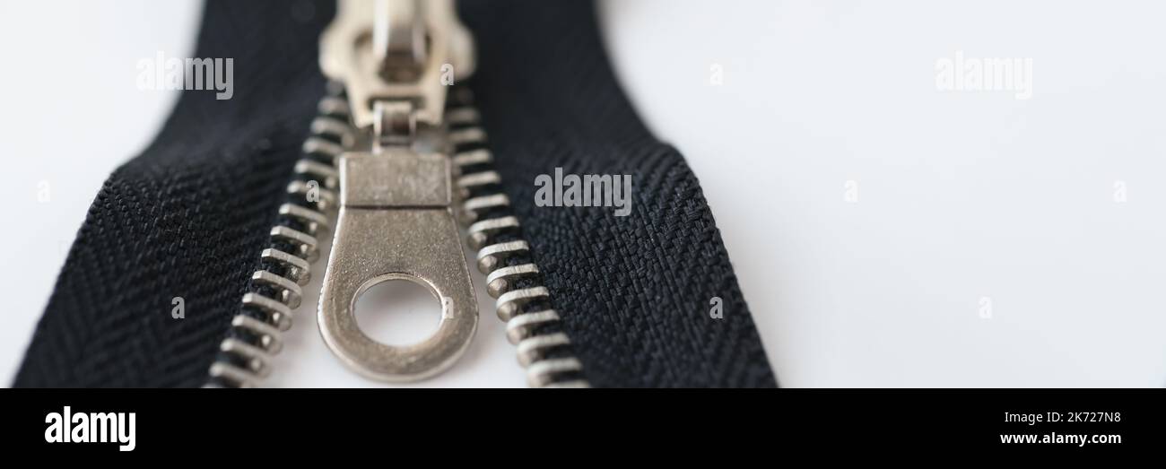 Closeup macro shot of open black brass zipper isolated on white background Stock Photo