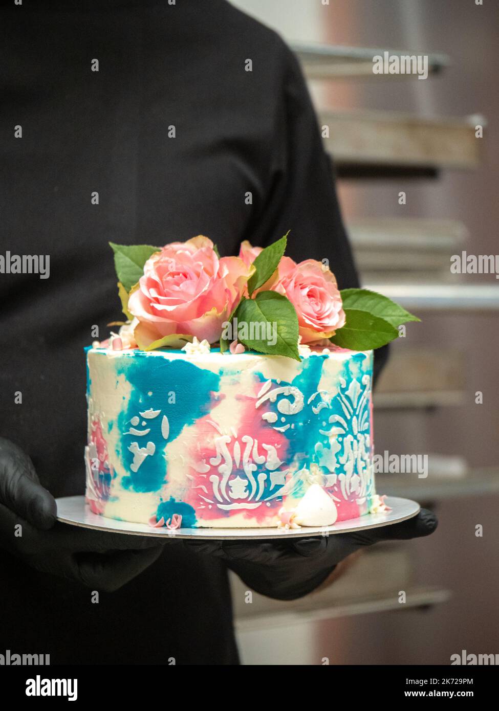 birthday pastel frosted cup cake with topping natural real roses and turquoise deco Stock Photo