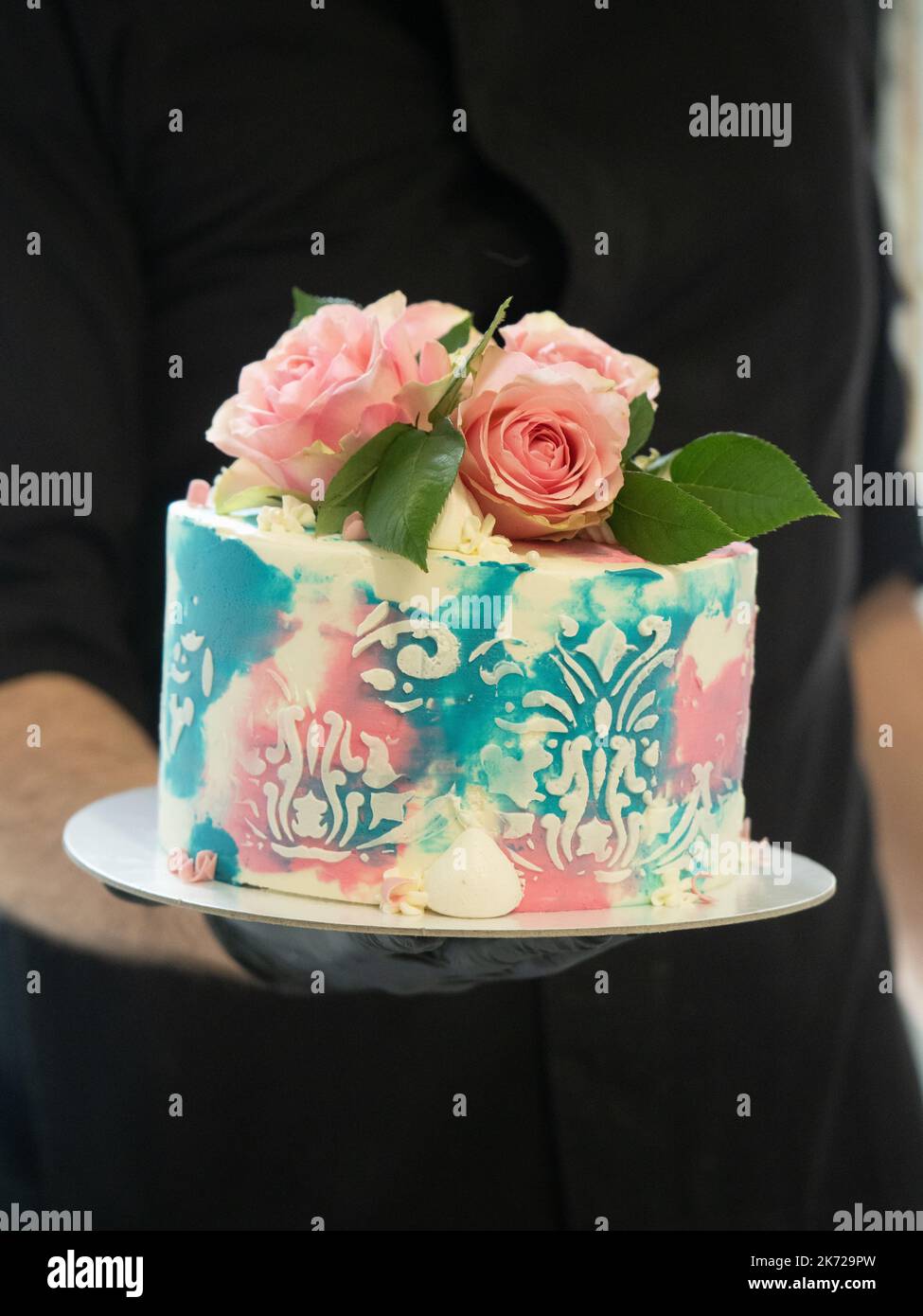 birthday pastel frosted cup cake with topping natural real roses and turquoise deco Stock Photo