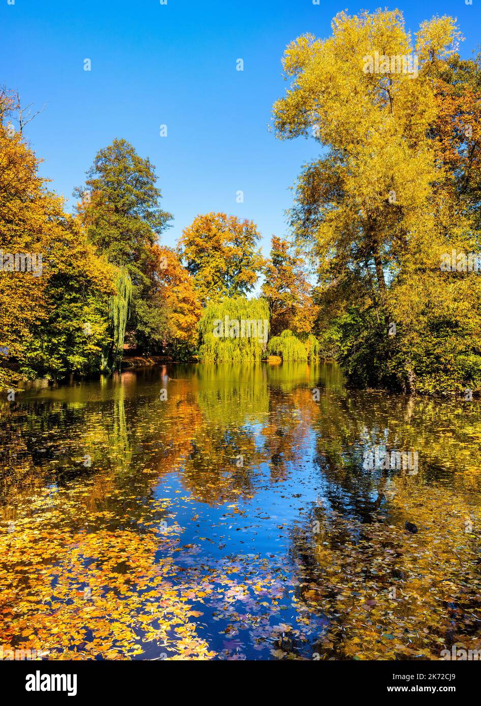 City park and lake with colorful fall trees in historic old town ...