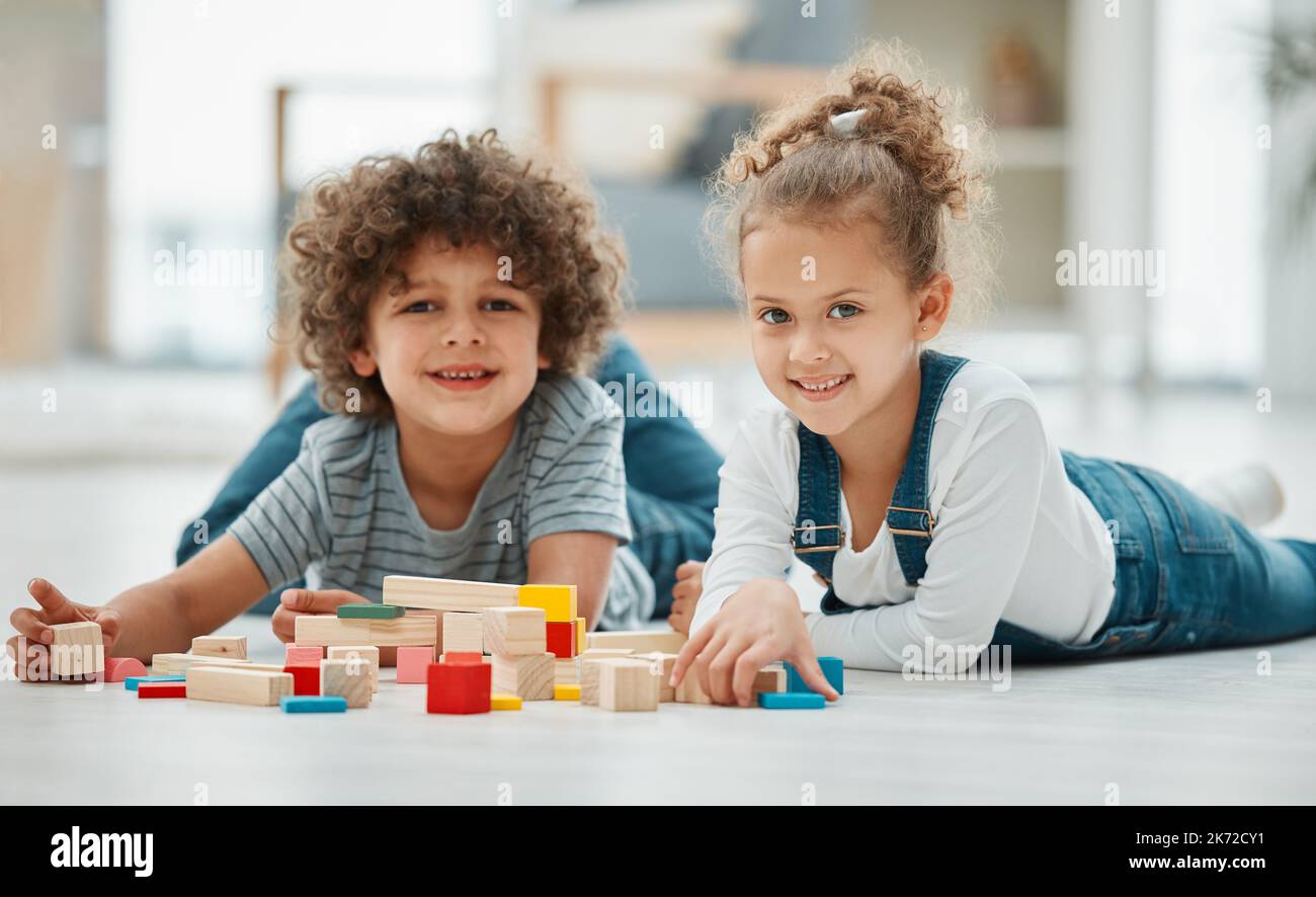 My brother is my best friend. two siblings playing with building blocks. Stock Photo