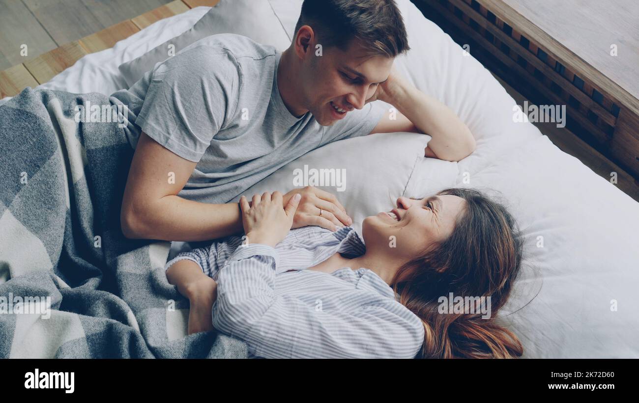 Sweet couple talking in bed hi-res stock photography and images photo image