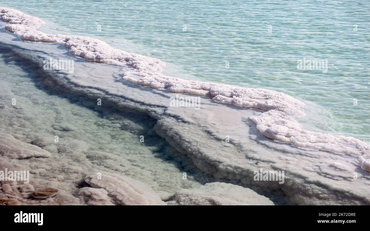 S-shaped salt formation snakes through an evaporation pond in the industrial area of the Dead Sea Yam Hamelah in Israel with clear aquamarine water Stock Photo