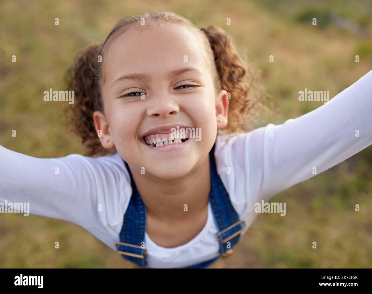 The outdoors is my happy place. an adorable little girl having fun