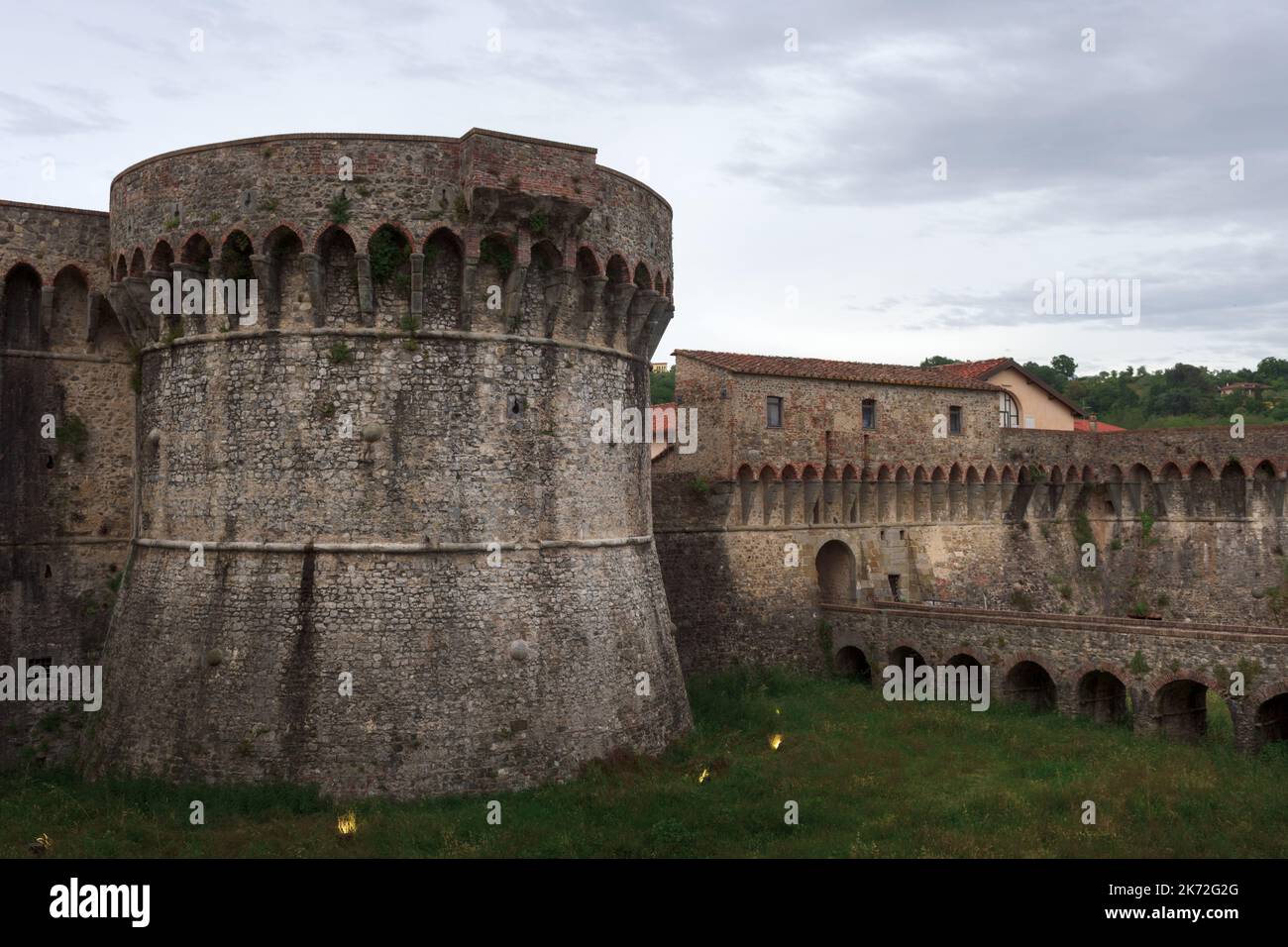 Towers and walls with bridge and moat of the medieval fortress of Firmafede in Sarzana, beautiful town in Liguria, Italy Stock Photo