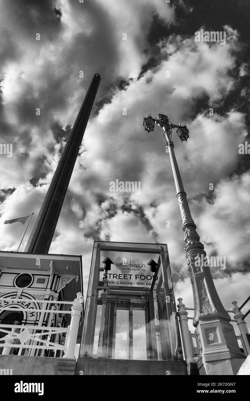 Black and white, low angle showing the British Airways i360 tower and the street lift on Brighton seafront Stock Photo