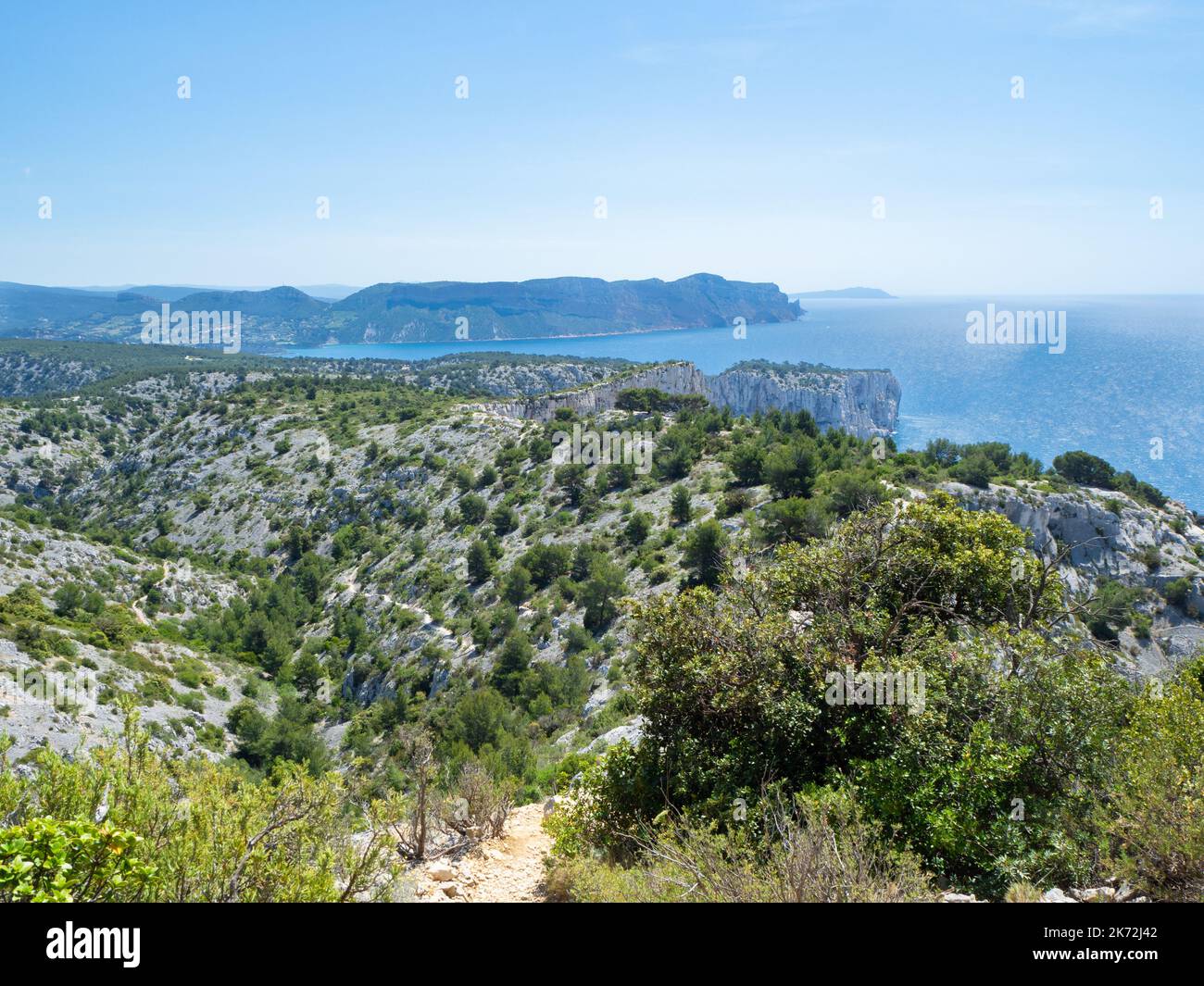 Calanques, France - May 20th 2020: Hiking high above the Mediterranean Sea along a rocky coast Stock Photo