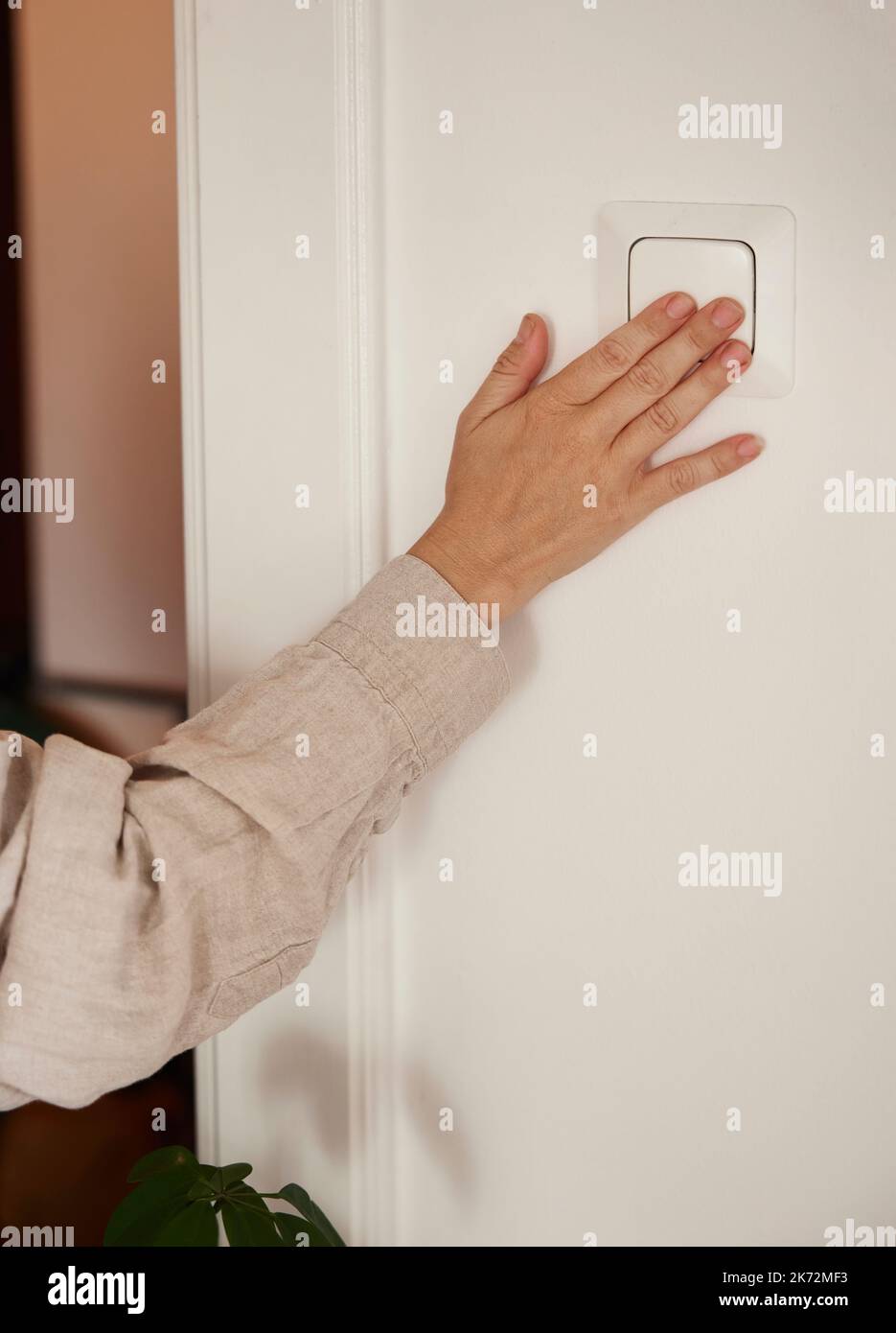 Woman turning on light Stock Photo Alamy