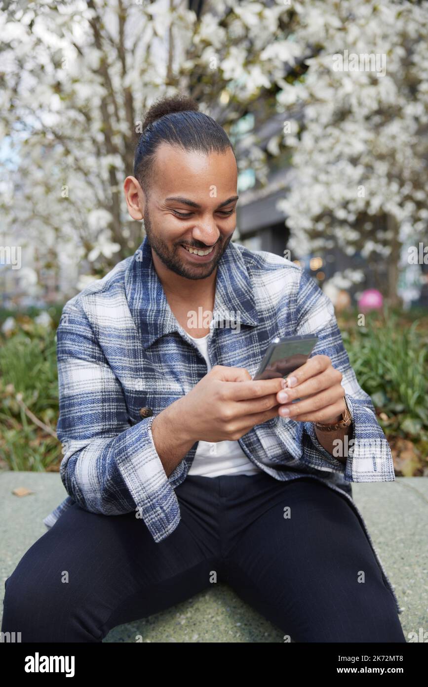 Smiling man using cell phone Stock Photo