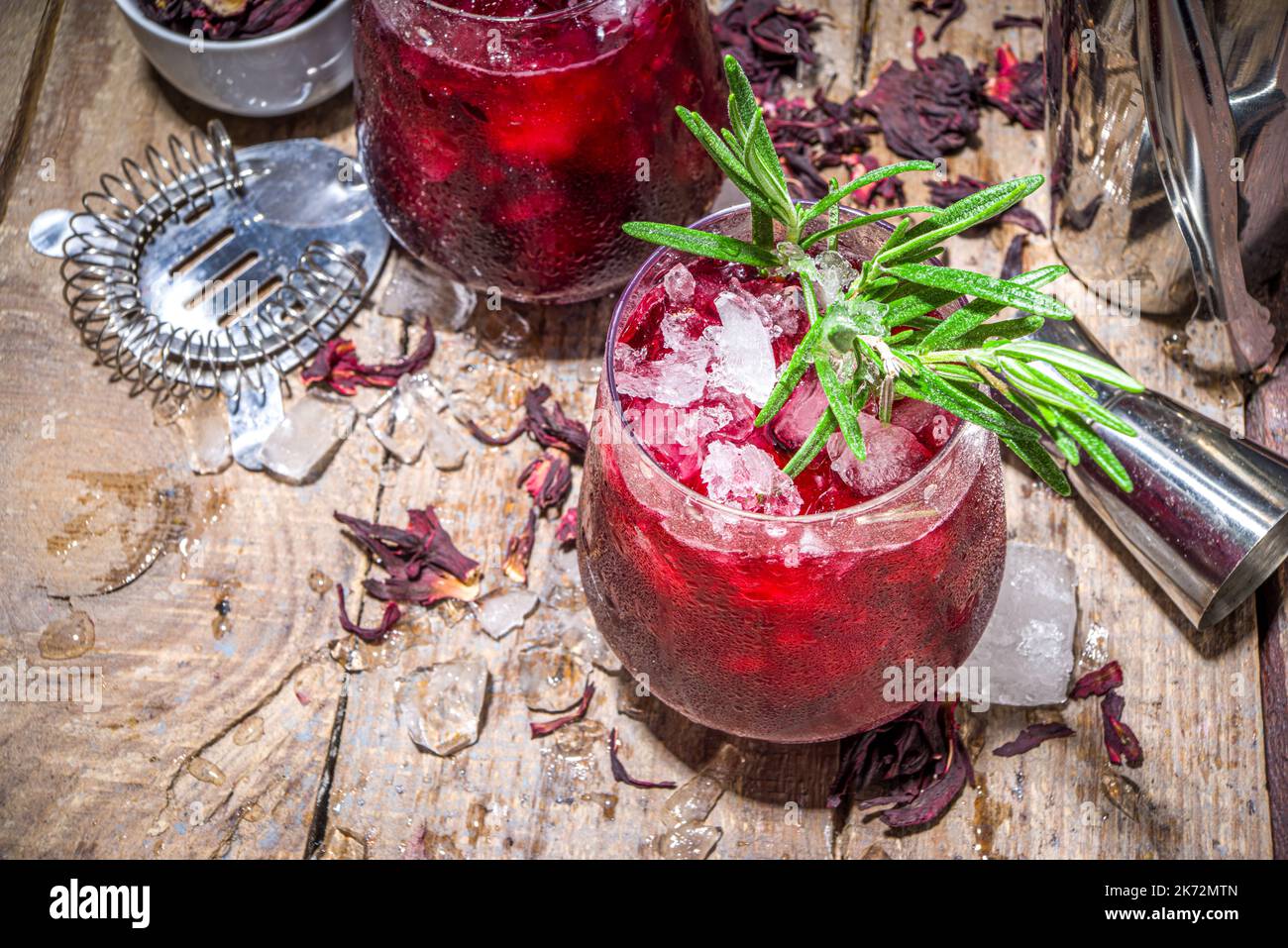 Cold autumn winter hibiscus cocktail with rosemary and crushed ice