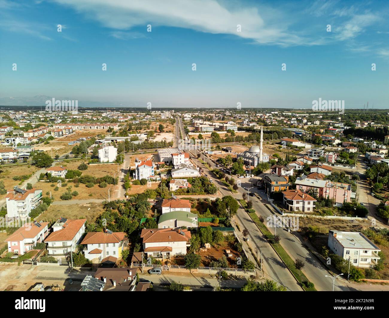 Aerial photograph of a town at sunset. A town with two-storey detached houses and a mosque Stock Photo