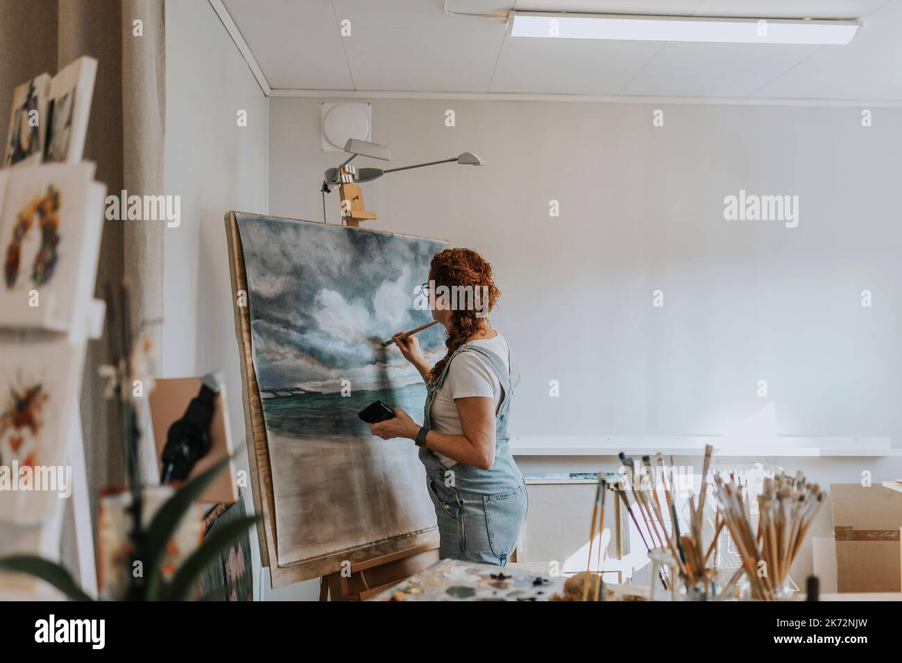 Artist painting in studio Stock Photo - Alamy