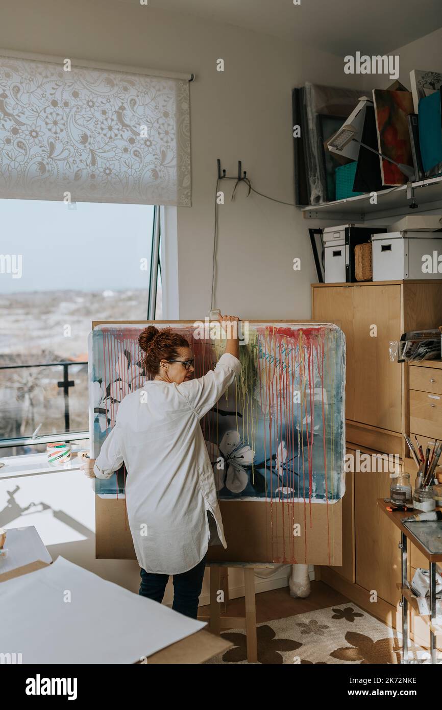 Artist preparing painting in studio Stock Photo