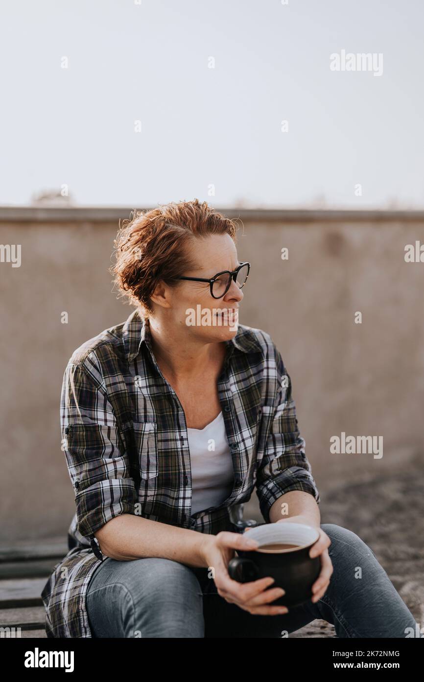 Smiling woman having coffee Stock Photo