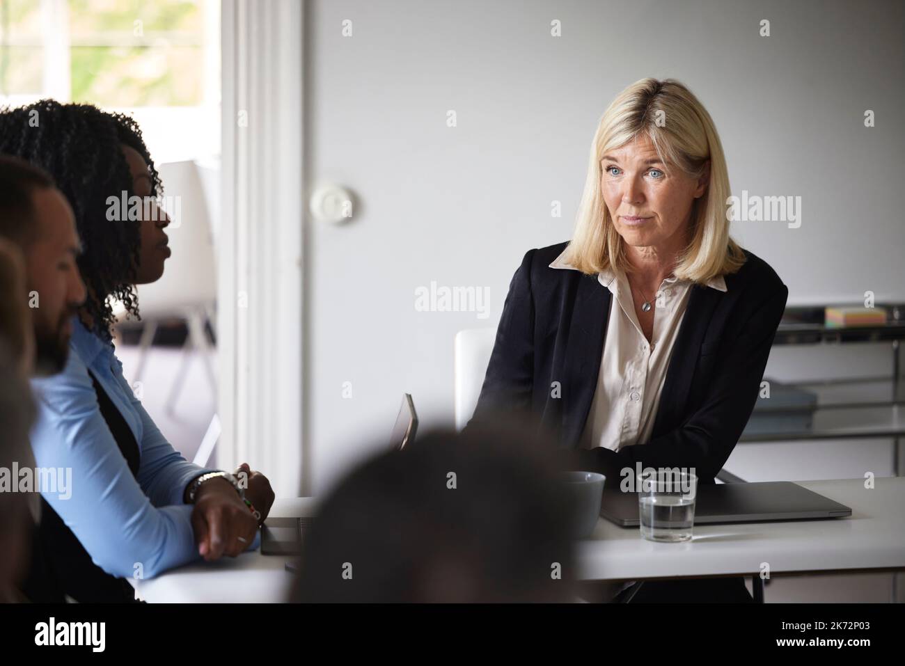 Smiling businesswoman at meeting Stock Photo