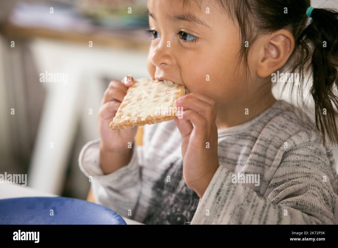 Girl eating bread Stock Photo Alamy
