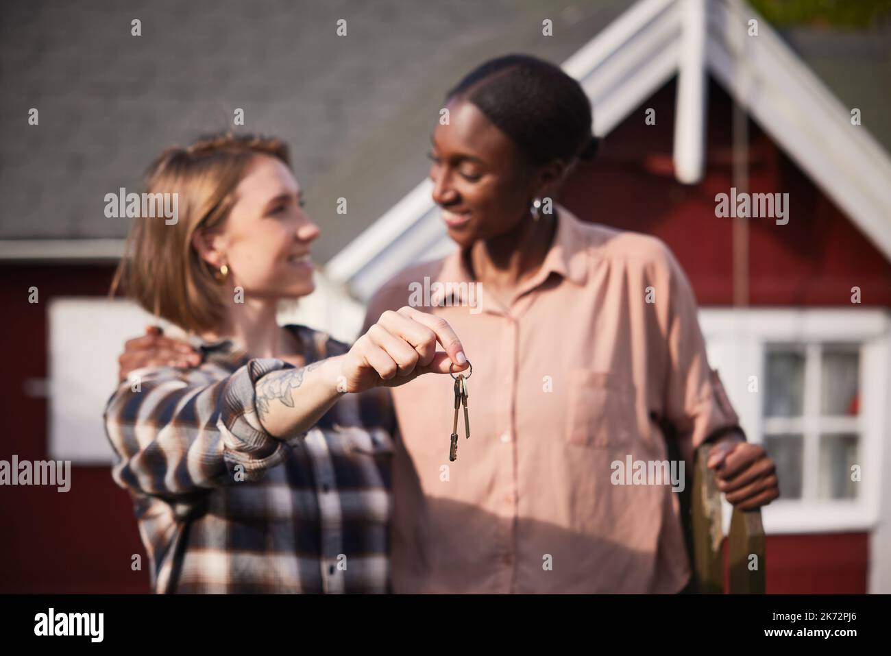 Smiling women holding house keys Stock Photo - Alamy