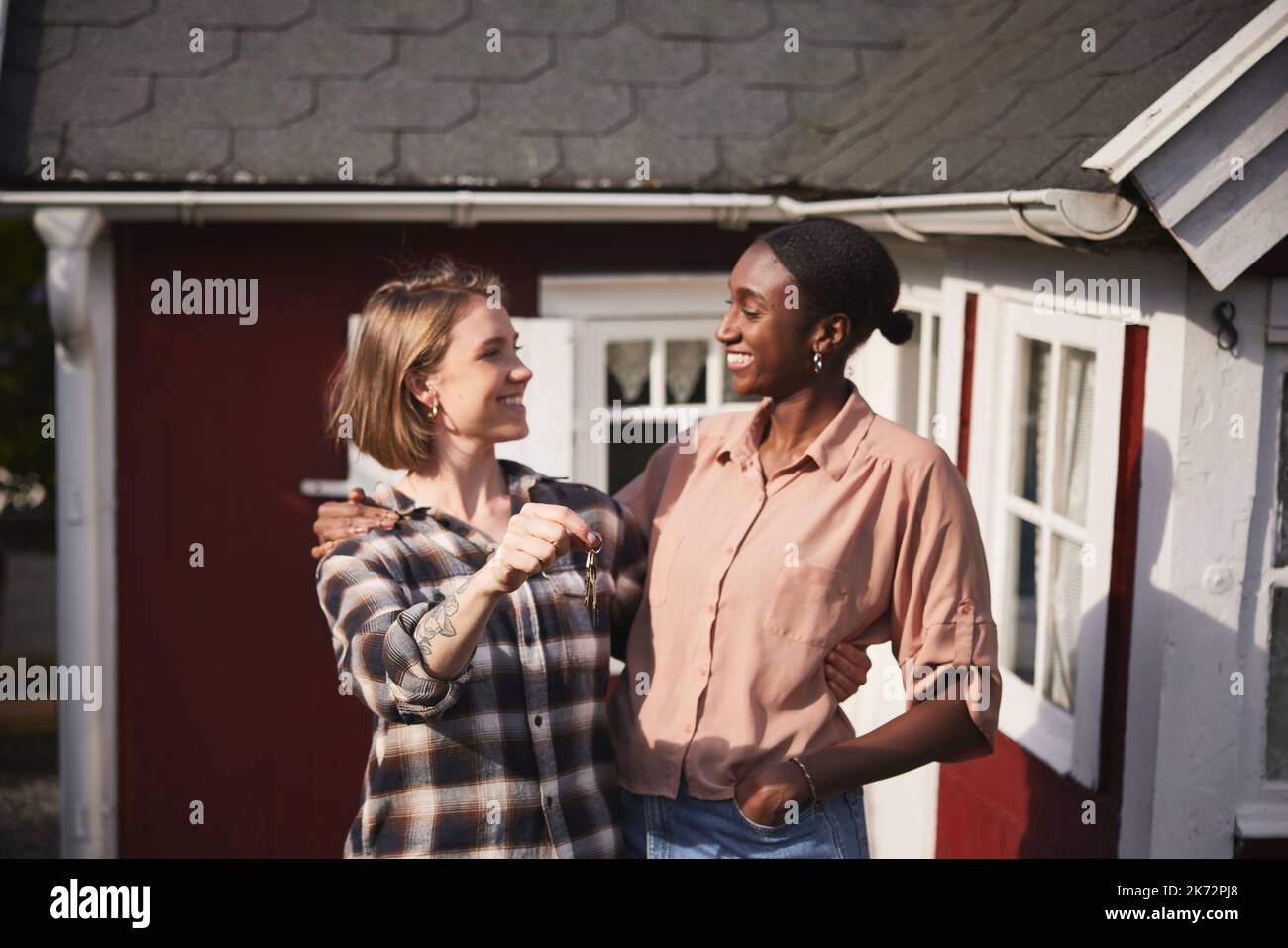 Smiling women holding house keys Stock Photo - Alamy