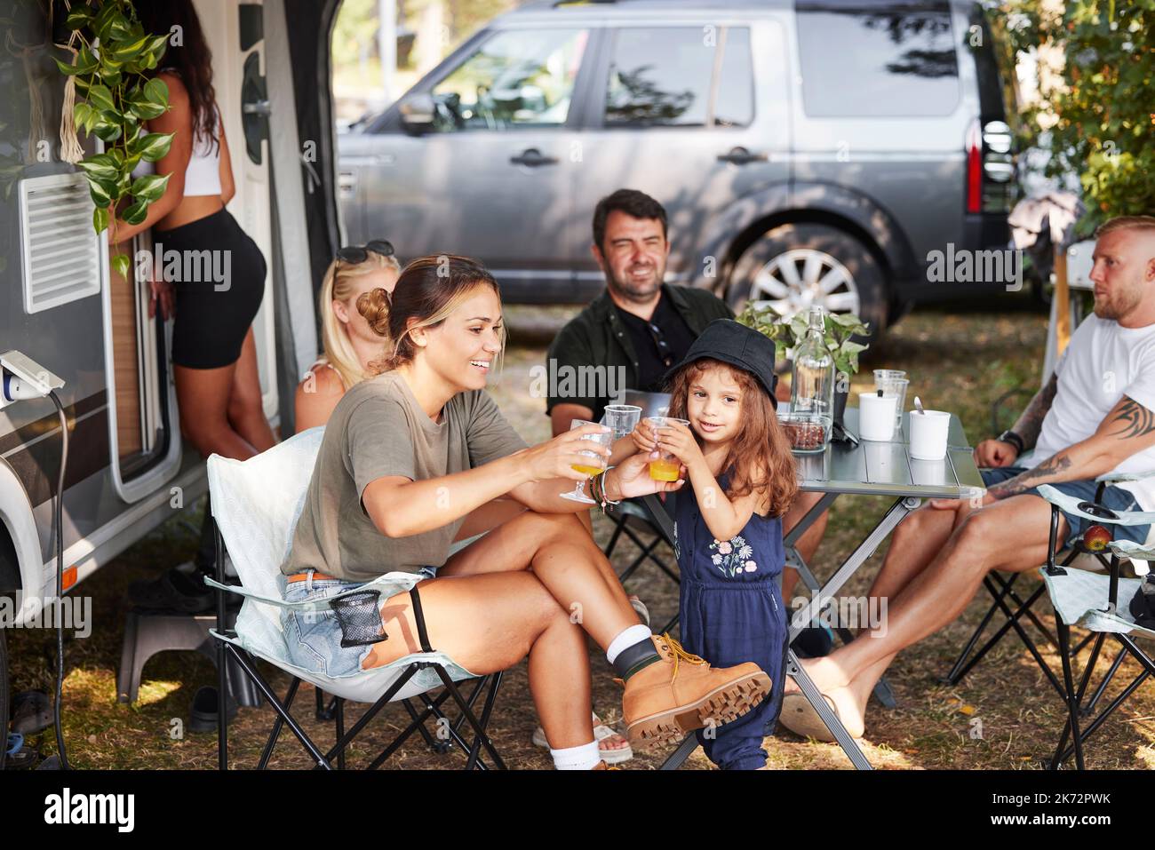 Family relaxing at camping site Stock Photo