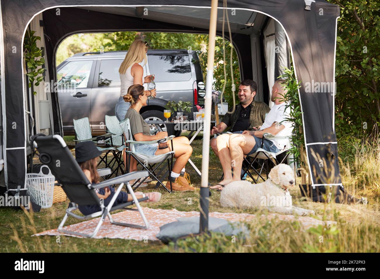 Family relaxing at camping site Stock Photo