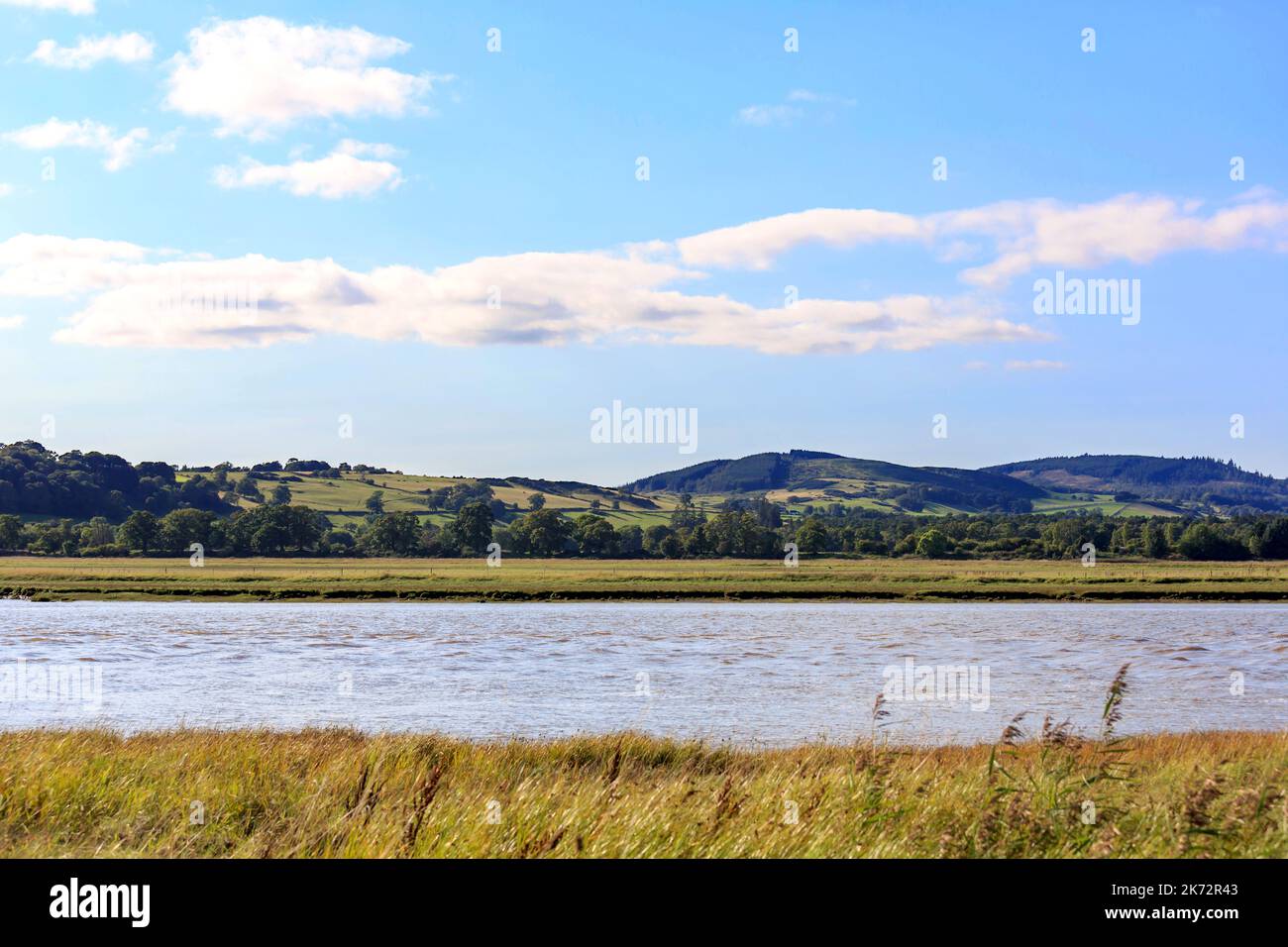 View over the River Nith towards farmland, trees and the hillsides of Dumfries and Galloway Scotland Stock Photo