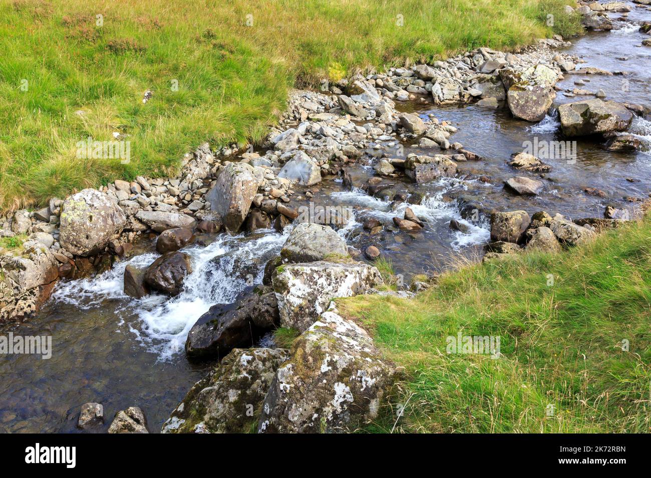 Water tumbling over rocks in a Scottish burn Stock Photo