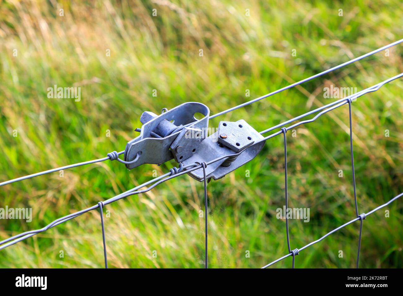 Close up on a pair of wire tensioner holding wire tight Stock Photo