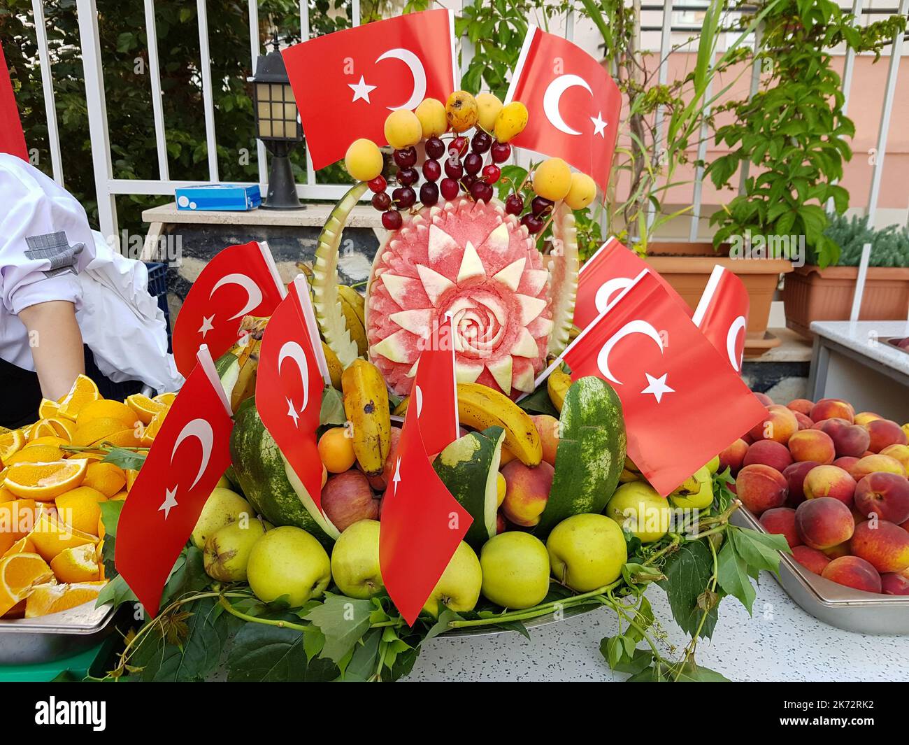 Fresh summer fruits in a watermelon basket decorated with Turkish flags. Composition with assorted fruits Stock Photo