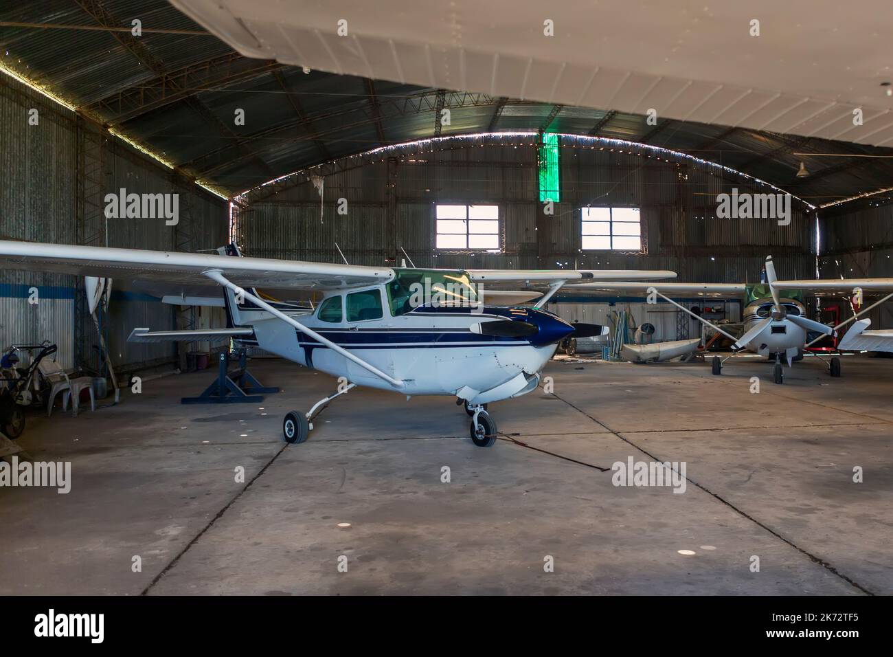 old angar with several airplanes ready for flight. Stock Photo