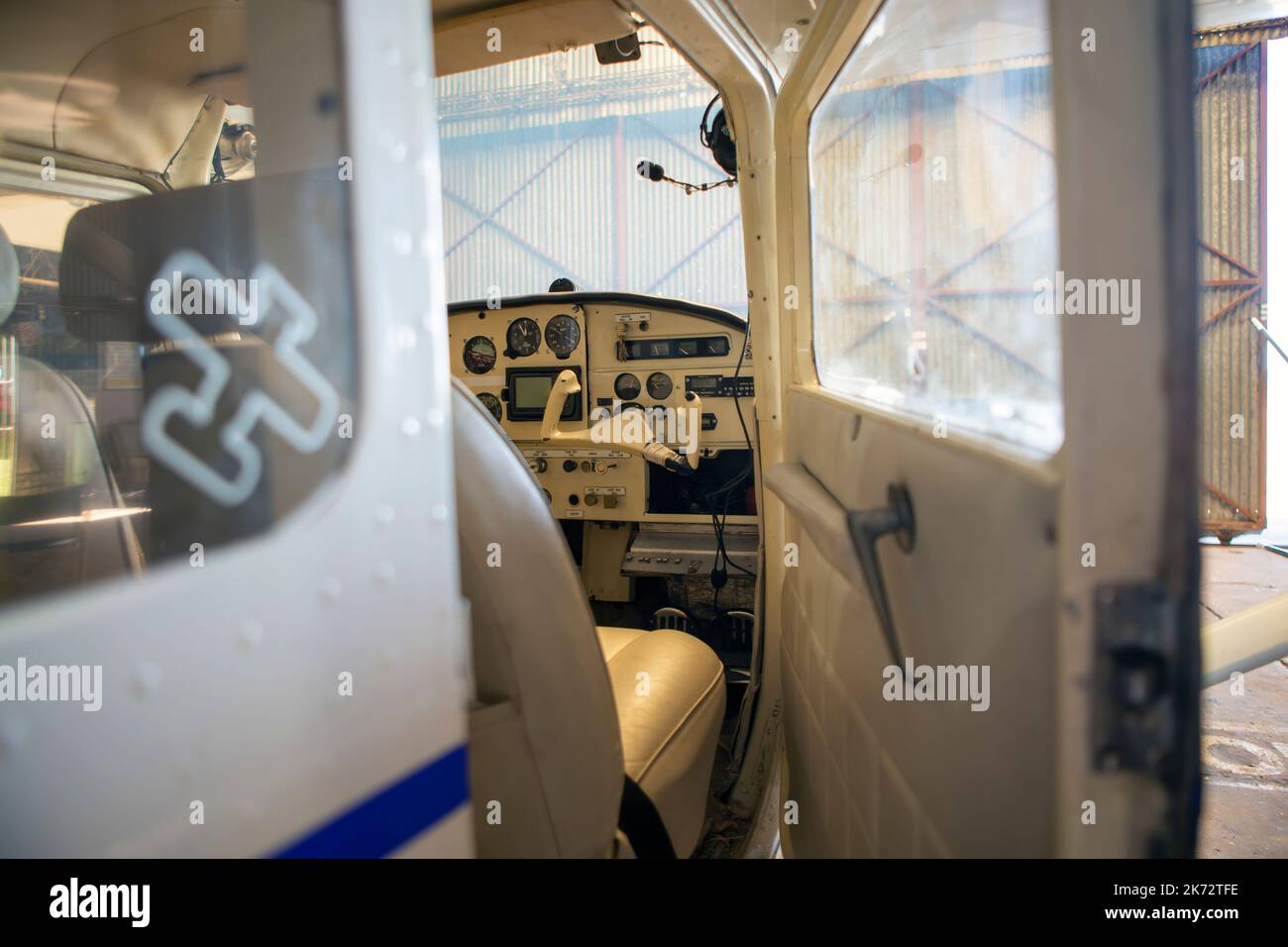 photo of aircraft cockpit seen from outside with door ajar Stock Photo